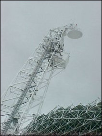 This is the feed arm, which holds the secondary reflector as well as the prime focus. Due to the GBT's unconventional design, this is the only thing blocking the GBT's "view". This, however, is compensated for by the GBT's ability to move around on its base, also enabling it to act as if it were over four times as big as it is.