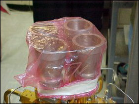 It's important to keep the actual collectors clean, thus the saran wrap. Out in the field, saran wrap is impractical for use, and so they actually use this blue foam at right. The blue foam is transparent to radio waves, and keeps stuff out.