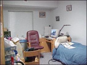 Next to the bed, I have arranged my two desks in an "L" shape, and mounted the computer on it.