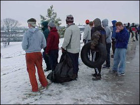 Meanwhile, everyone stands up at the top of the hill planning a strategy for their next slide, especially those going over the makeshift snow ramp.
