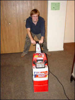 Back at Sojourner House after lunch, Spencer and Nicole ham it up for the camera with the Rug Doctor machines.
