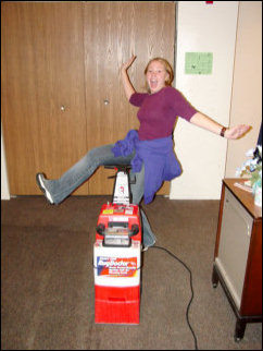 Back at Sojourner House after lunch, Spencer and Nicole ham it up for the camera with the Rug Doctor machines.