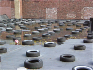 A strange sight! The building next to Sojourner House had tires placed all over the roof.