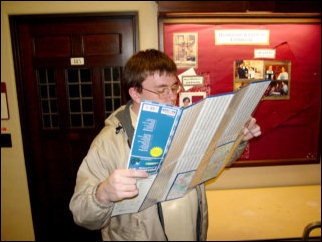 Patrick takes a look-see at a map, in order to help best direct Kathleen to a movie theater that was playing the Luther movie.