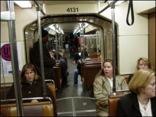 The T uses articulated light rail vehicles. Each light rail vehicle is two "cars", connected by a hinge in the middle (I'm oversimplifying, but you get the idea). Additionally, the lights go out for a few seconds inside the cars when the trains change wires. Only the blue lights stay on during these changeovers.