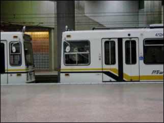 Inside some of the underground stations, passengers disembark, and trains sit idle on a side track.